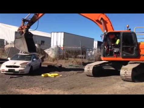 mini excavator crushing a car|Smashing car with an excavator .